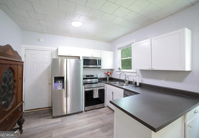 430 Sherwood Cir, Danielsville, GA 30633 - kitchen featuring stainless steel appliances, dark countertops, white cabinets, light wood-type flooring, and crown molding