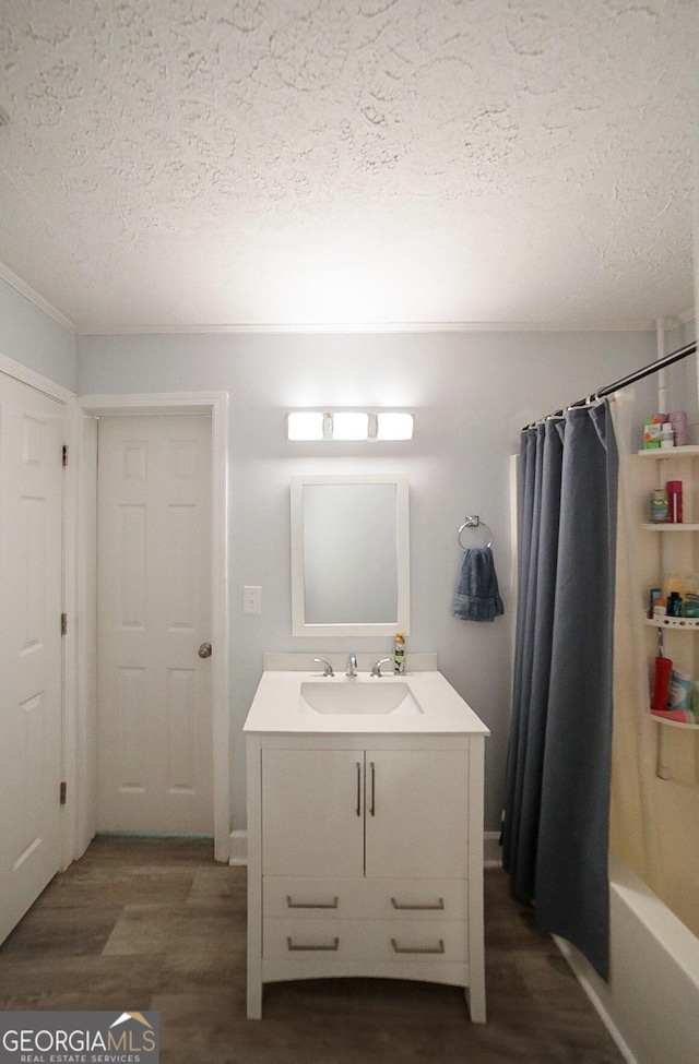 430 Sherwood Cir, Danielsville, GA 30633 - full bath with a textured ceiling, vanity, wood finished floors, and shower / bathtub combination with curtain