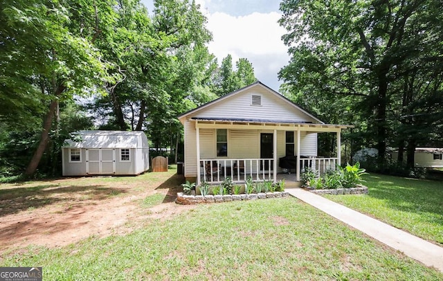 430 Sherwood Cir, Danielsville, GA 30633 - view of front facade with a porch, a storage shed, and a front yard