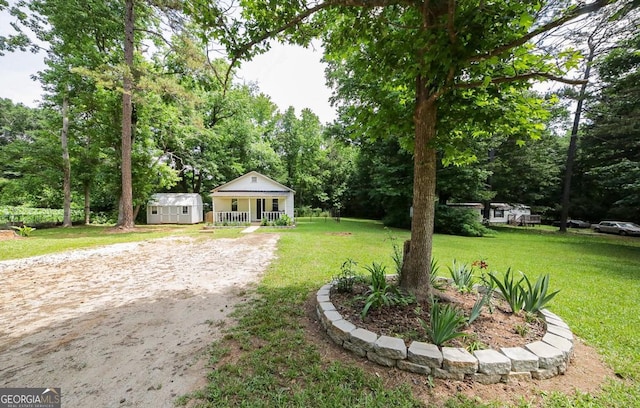 430 Sherwood Cir, Danielsville, GA 30633 - view of grassy yard with a storage shed and a porch
