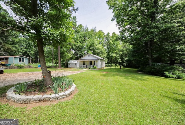 430 Sherwood Cir, Danielsville, GA 30633 - view of green lawn featuring a porch and view of scattered trees