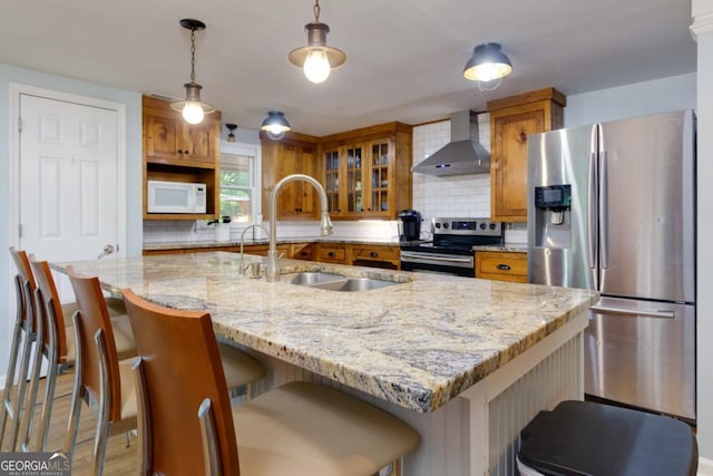 3835 Clubhouse Cir, Gainesville, GA 30501 - kitchen with appliances with stainless steel finishes, wall chimney exhaust hood, a sink, brown cabinets, and backsplash