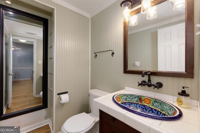 3835 Clubhouse Cir, Gainesville, GA 30501 - bathroom with crown molding, vanity, toilet, wood finished floors, and baseboards