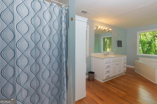 3835 Clubhouse Cir, Gainesville, GA 30501 - full bath featuring wood finished floors, vanity, baseboards, curtained shower, and a bath