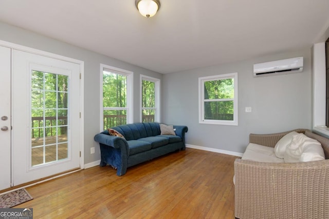 3835 Clubhouse Cir, Gainesville, GA 30501 - living area with a wall mounted air conditioner, light wood-type flooring, baseboards, and healthy amount of natural light