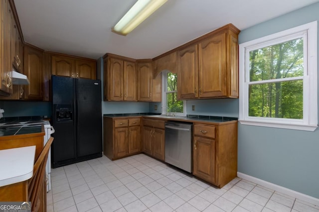 3835 Clubhouse Cir, Gainesville, GA 30501 - kitchen with black refrigerator with ice dispenser, dishwasher, brown cabinets, under cabinet range hood, and baseboards