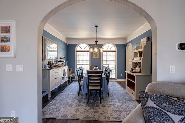 157 Riverbend Cir, Royston, GA 30662 - dining area with a chandelier, dark wood finished floors, crown molding, and arched walkways