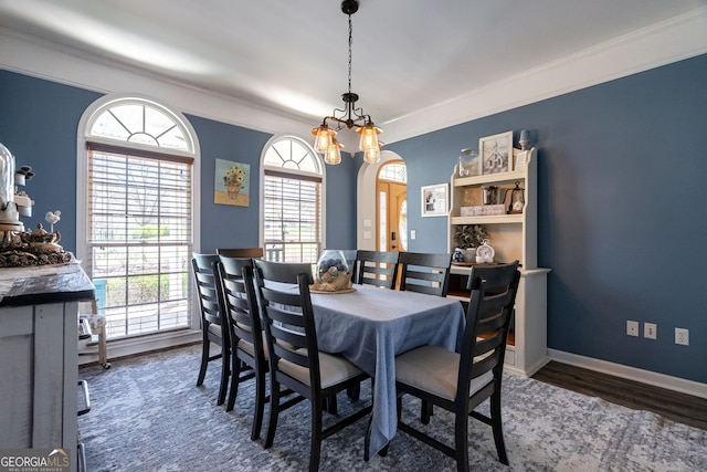 157 Riverbend Cir, Royston, GA 30662 - dining space with healthy amount of natural light, crown molding, wood finished floors, a chandelier, and baseboards