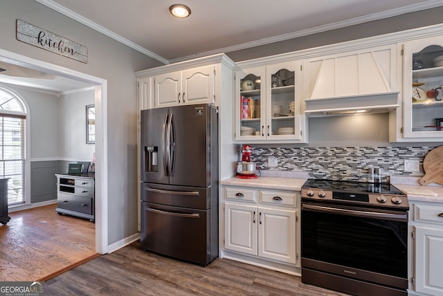 157 Riverbend Cir, Royston, GA 30662 - kitchen featuring appliances with stainless steel finishes, custom exhaust hood, light countertops, white cabinets, and ornamental molding