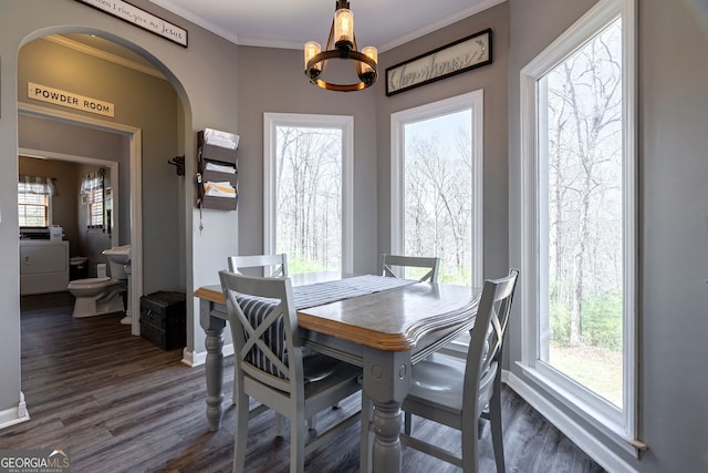 157 Riverbend Cir, Royston, GA 30662 - dining space with arched walkways, dark wood-style floors, a chandelier, baseboards, and ornamental molding
