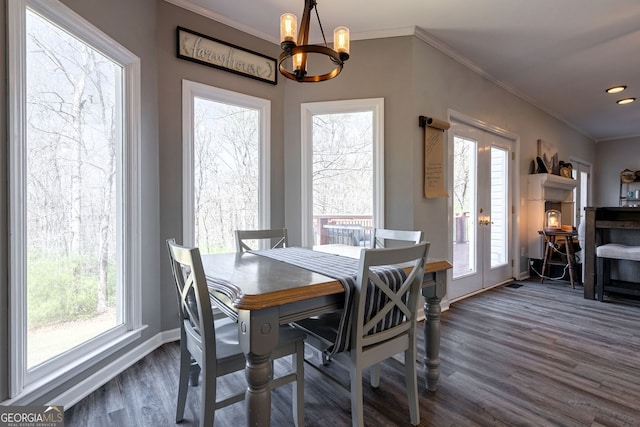 157 Riverbend Cir, Royston, GA 30662 - dining room featuring a chandelier, plenty of natural light, dark wood-style floors, ornamental molding, and baseboards