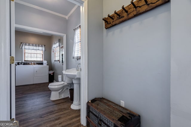157 Riverbend Cir, Royston, GA 30662 - half bathroom featuring washing machine and clothes dryer, ornamental molding, toilet, wood finished floors, and a sink