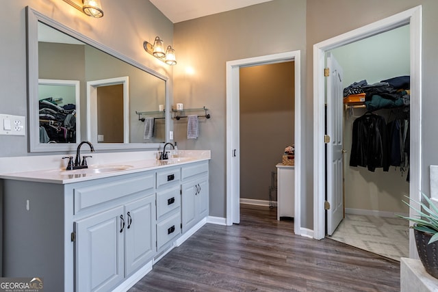 157 Riverbend Cir, Royston, GA 30662 - full bathroom with double vanity, a spacious closet, wood finished floors, and baseboards