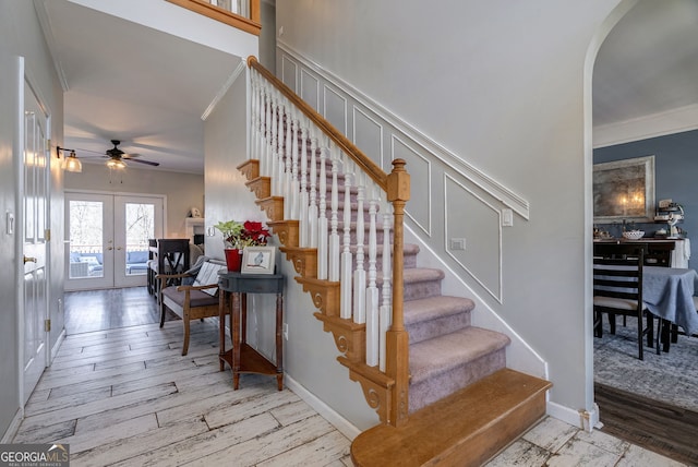 157 Riverbend Cir, Royston, GA 30662 - stairs featuring ornamental molding, wood finished floors, a ceiling fan, arched walkways, and french doors