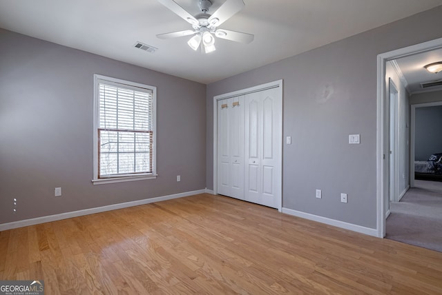 157 Riverbend Cir, Royston, GA 30662 - unfurnished bedroom with baseboards, light wood-type flooring, a closet, and a ceiling fan