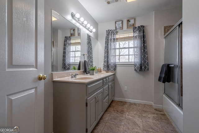 157 Riverbend Cir, Royston, GA 30662 - full bath with double vanity, healthy amount of natural light, enclosed tub / shower combo, and baseboards