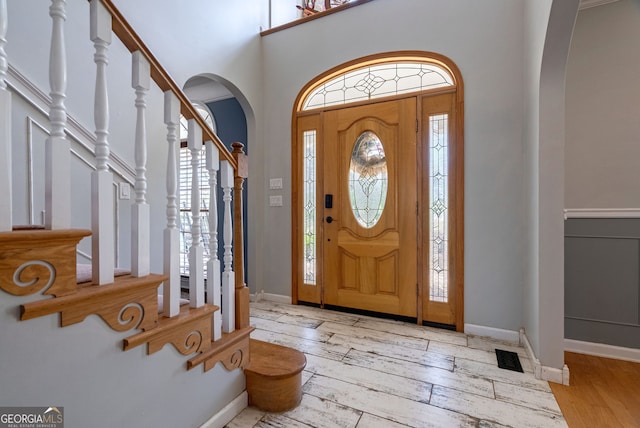 157 Riverbend Cir, Royston, GA 30662 - entryway featuring arched walkways, stairs, hardwood / wood-style flooring, baseboards, and a high ceiling