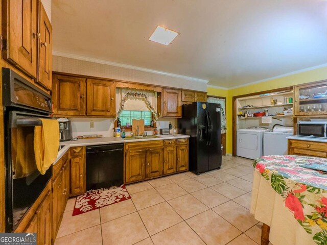 2000 Stone Mountain Lithonia Rd, Lithonia, GA 30058 - kitchen featuring black appliances, washer and clothes dryer, crown molding, light countertops, and brown cabinetry