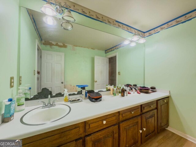 2000 Stone Mountain Lithonia Rd, Lithonia, GA 30058 - bathroom with vanity, wood finished floors, and baseboards