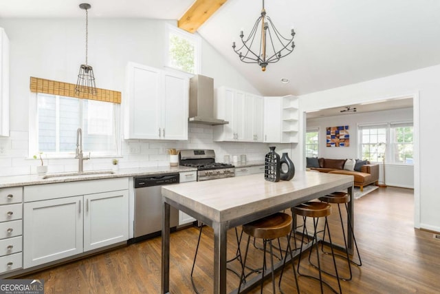 936 Ormewood Ter SE, Atlanta, GA 30316 - kitchen featuring appliances with stainless steel finishes, a sink, wall chimney range hood, dark wood finished floors, and tasteful backsplash