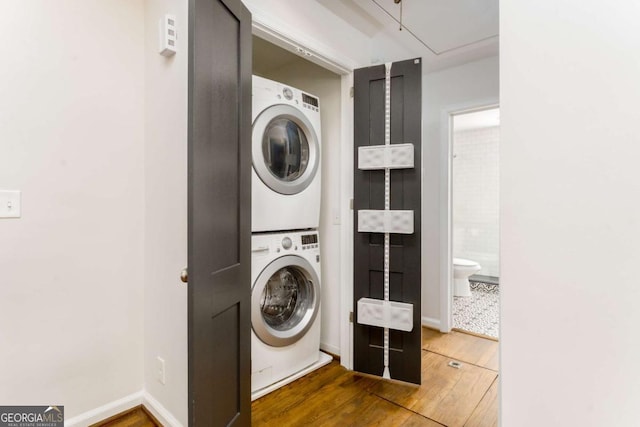936 Ormewood Ter SE, Atlanta, GA 30316 - laundry room featuring stacked washing machine and dryer, hardwood / wood-style floors, attic access, and baseboards