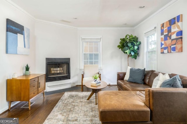 936 Ormewood Ter SE, Atlanta, GA 30316 - living room featuring dark wood-style floors, a fireplace with raised hearth, crown molding, and baseboards