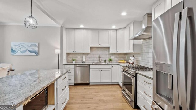 3532 Paces Pl NW, Atlanta, GA 30327 - kitchen with stainless steel appliances, wall chimney exhaust hood, backsplash, ornamental molding, and light stone countertops