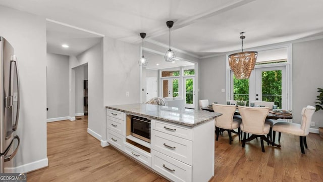 3532 Paces Pl NW, Atlanta, GA 30327 - kitchen with stainless steel refrigerator with ice dispenser, white cabinets, light stone counters, light wood-style floors, and a chandelier