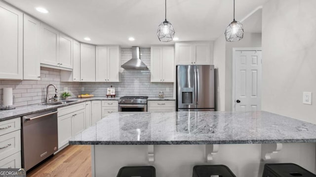 3532 Paces Pl NW, Atlanta, GA 30327 - kitchen featuring stainless steel appliances, wall chimney exhaust hood, a kitchen bar, tasteful backsplash, and recessed lighting