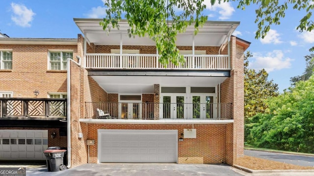 3532 Paces Pl NW, Atlanta, GA 30327 - back of house with a balcony, brick siding, and an attached garage
