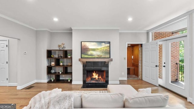 3532 Paces Pl NW, Atlanta, GA 30327 - living area featuring a warm lit fireplace, crown molding, wood finished floors, and recessed lighting