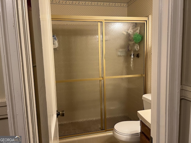 608 4th Ave SW, Thomaston, GA 30286 - bathroom with toilet, vanity, a stall shower, and wallpapered walls