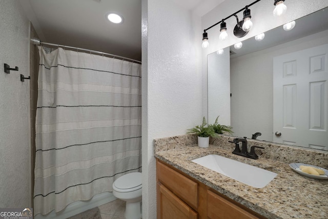 1445 Monroe Dr NE Unit C13, Atlanta, GA 30324 - bathroom featuring vanity, a textured wall, tile patterned flooring, and recessed lighting