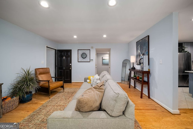 1445 Monroe Dr NE Unit C13, Atlanta, GA 30324 - living room with light wood-style floors, recessed lighting, and arched walkways