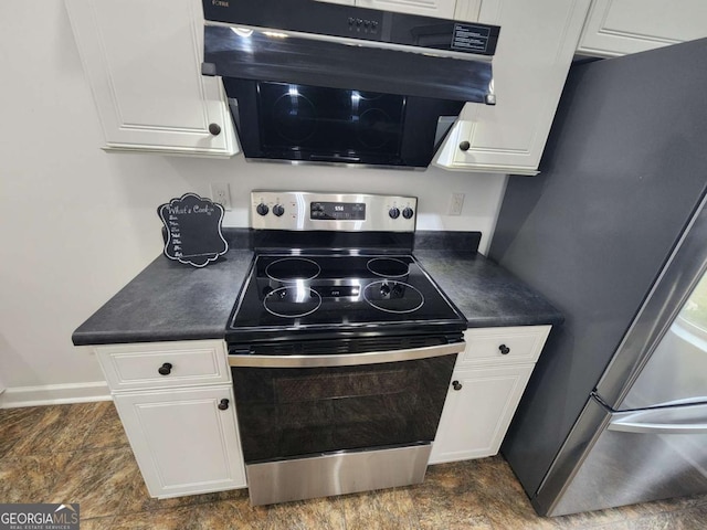 206 York Way, Augusta, GA 30909 - kitchen featuring appliances with stainless steel finishes, dark countertops, white cabinetry, stone finish flooring, and baseboards