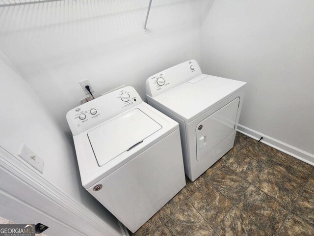 206 York Way, Augusta, GA 30909 - laundry area featuring washing machine and clothes dryer, stone finish flooring, and baseboards