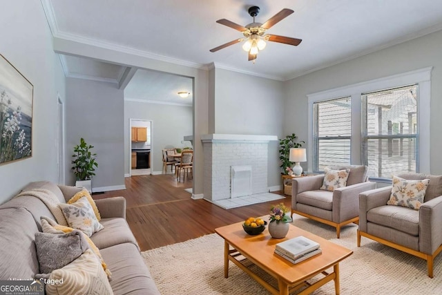 3361 Myrtle St, Atlanta, GA 30354 - living room with wood finished floors, a ceiling fan, crown molding, and a brick fireplace