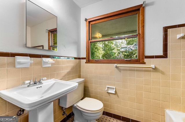 511 Oakview Rd, Decatur, GA 30030 - full bath with tile walls, toilet, wainscoting, and a tub to relax in
