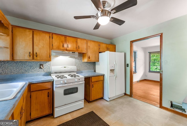 511 Oakview Rd, Decatur, GA 30030 - kitchen with white appliances, under cabinet range hood, tasteful backsplash, brown cabinets, and ceiling fan