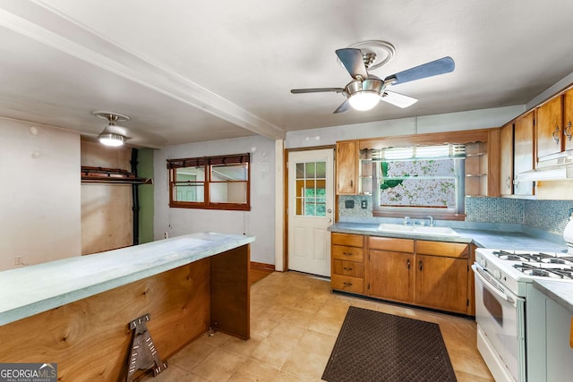 511 Oakview Rd, Decatur, GA 30030 - kitchen with gas range gas stove, a sink, light countertops, a ceiling fan, and under cabinet range hood