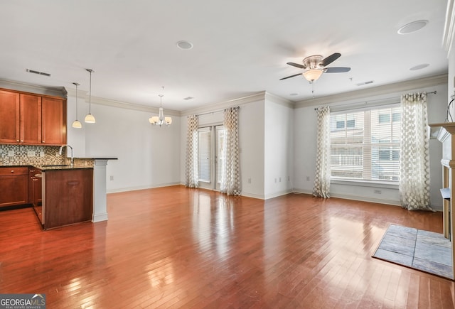 1199 Lavista Rd NE, Atlanta, GA 30324 - unfurnished living room featuring a chandelier, ceiling fan, hardwood / wood-style flooring, baseboards, and ornamental molding