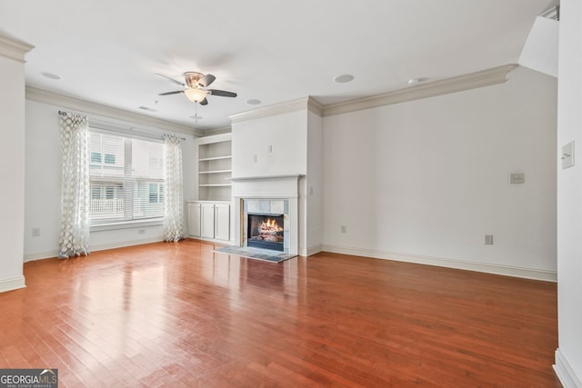 1199 Lavista Rd NE, Atlanta, GA 30324 - unfurnished living room with ornamental molding, ceiling fan, a tile fireplace, wood finished floors, and built in features