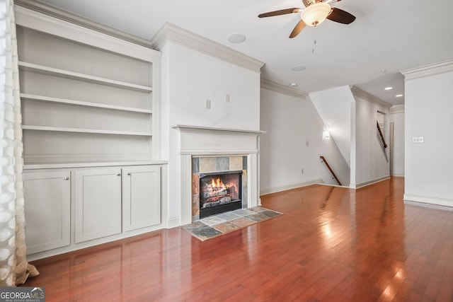 1199 Lavista Rd NE, Atlanta, GA 30324 - unfurnished living room with crown molding, ceiling fan, wood finished floors, built in features, and a tile fireplace