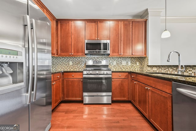 1199 Lavista Rd NE, Atlanta, GA 30324 - kitchen with appliances with stainless steel finishes, dark stone countertops, decorative backsplash, wood finished floors, and pendant lighting