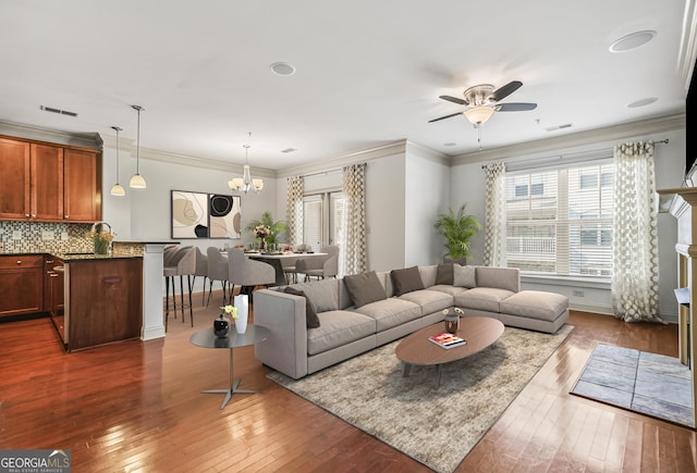 1199 Lavista Rd NE, Atlanta, GA 30324 - living area featuring dark wood-type flooring, a chandelier, a ceiling fan, and ornamental molding