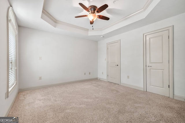 1199 Lavista Rd NE, Atlanta, GA 30324 - unfurnished bedroom with a tray ceiling, carpet floors, multiple windows, and crown molding
