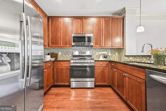 1199 Lavista Rd NE, Atlanta, GA 30324 - kitchen with stainless steel appliances, dark stone countertops, decorative backsplash, and crown molding