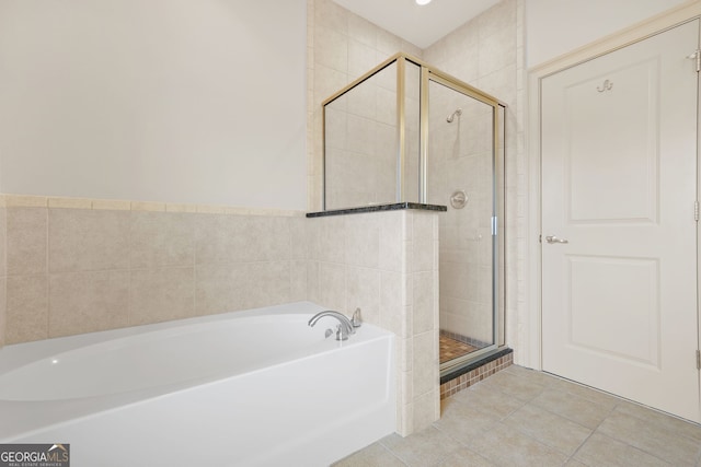 1199 Lavista Rd NE, Atlanta, GA 30324 - bathroom with a bath, a shower stall, and tile patterned flooring