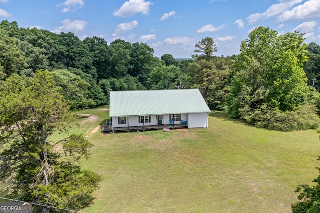 653 Fort Lamar Rd, Commerce, GA 30530 - view of front of home featuring a front lawn, a forest view, metal roof, and a deck