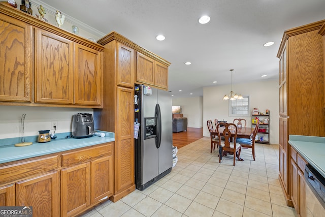 653 Fort Lamar Rd, Commerce, GA 30530 - kitchen with stainless steel refrigerator with ice dispenser, brown cabinets, paneled dishwasher, light countertops, and a chandelier